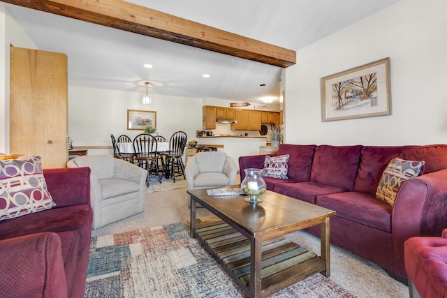 carpeted living room with vaulted ceiling with beams