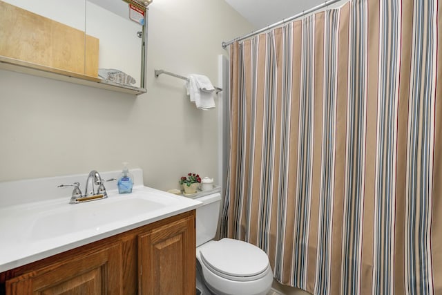 bathroom featuring vanity, toilet, and a shower with shower curtain