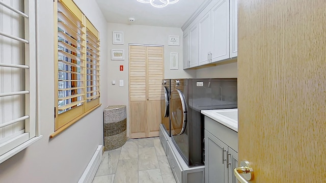 laundry room with marble finish floor, cabinet space, baseboards, and separate washer and dryer