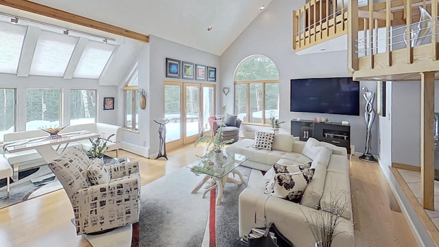 living room with high vaulted ceiling, beamed ceiling, baseboards, and wood finished floors