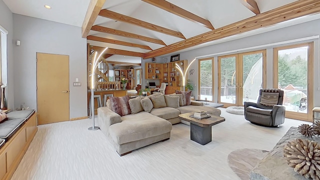 living area featuring vaulted ceiling with beams, french doors, a wealth of natural light, and recessed lighting