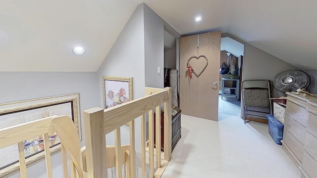 hallway featuring lofted ceiling, light carpet, an upstairs landing, and recessed lighting