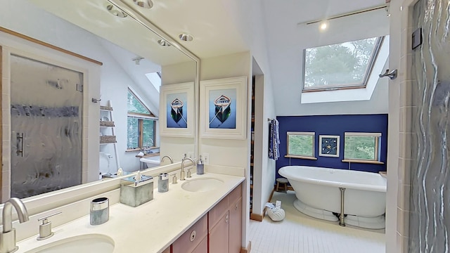 bathroom with double vanity, a stall shower, a freestanding tub, and a sink