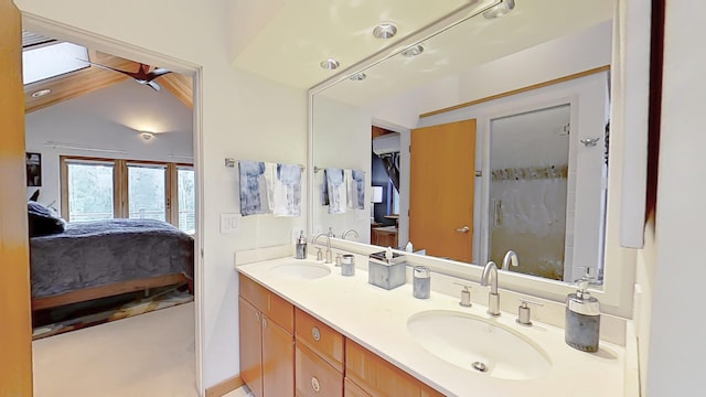 full bath featuring ensuite bathroom, double vanity, a sink, and a shower with shower door