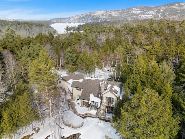 drone / aerial view featuring a mountain view and a wooded view