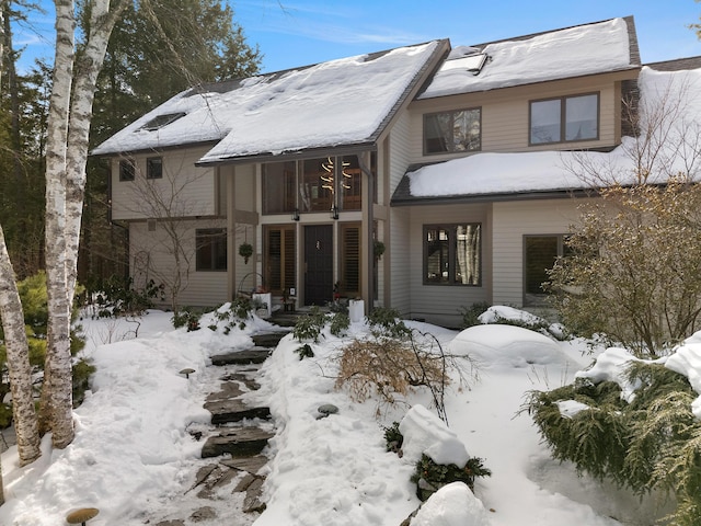 view of snow covered rear of property