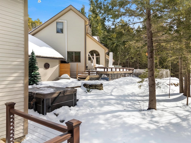 snow covered deck featuring a hot tub