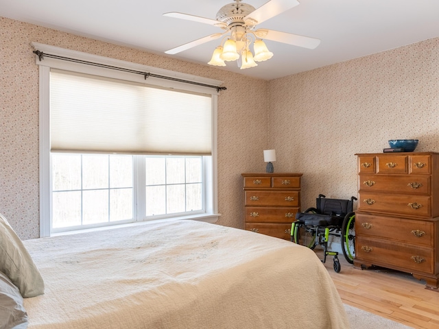 27 Orchard Ln, Minot, ME 04258 - bedroom featuring wood finished floors, wallpapered walls, and ceiling fan