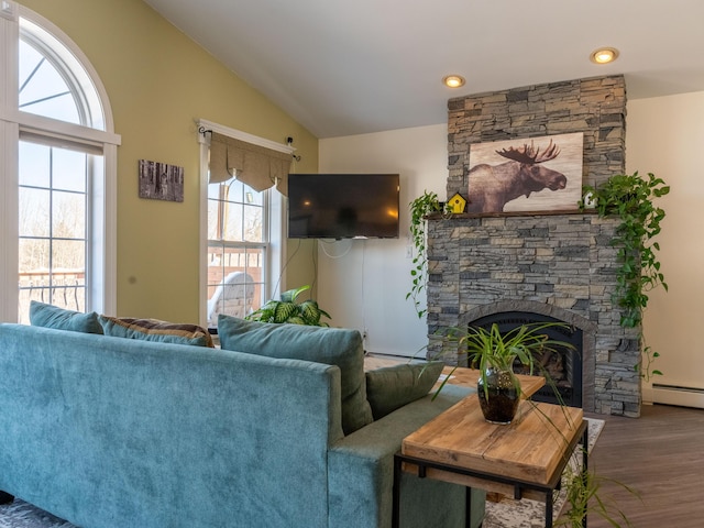 27 Orchard Ln, Minot, ME 04258 - living area with plenty of natural light, vaulted ceiling, wood finished floors, and a stone fireplace