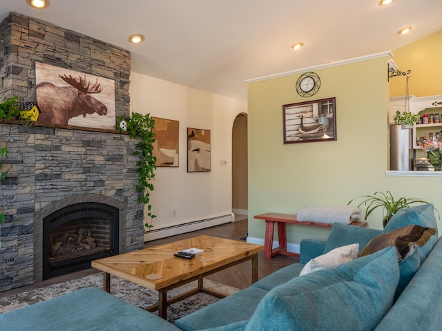 27 Orchard Ln, Minot, ME 04258 - living room with a baseboard radiator, arched walkways, wood finished floors, a fireplace, and recessed lighting