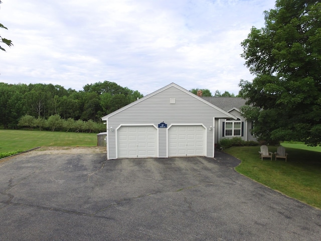 27 Orchard Ln, Minot, ME 04258 - view of front facade with driveway, an attached garage, and a front yard
