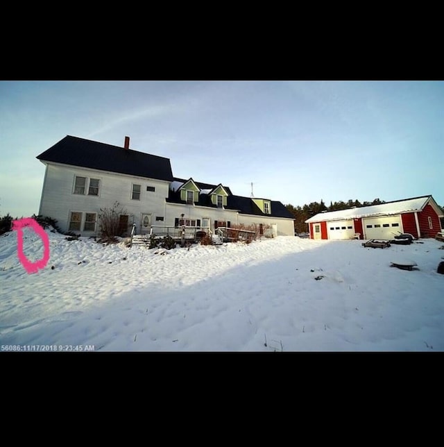 yard covered in snow featuring a garage