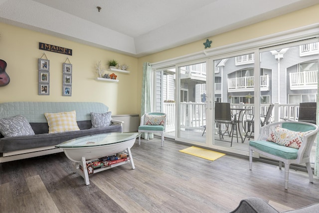 living room featuring lofted ceiling and wood-type flooring