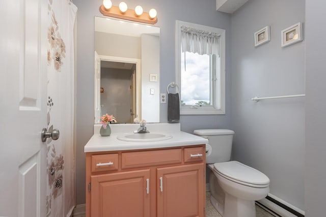 bathroom with a baseboard radiator, vanity, and toilet