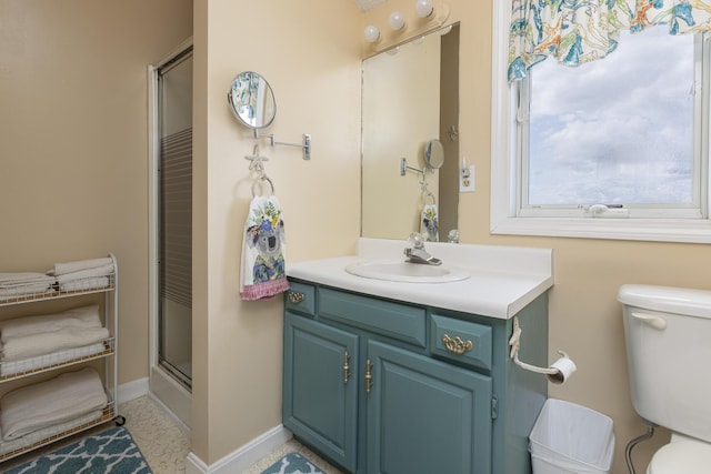 bathroom featuring vanity, an enclosed shower, and toilet