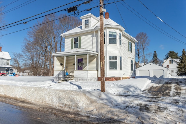 view of front of property featuring a garage, an outbuilding, and covered porch