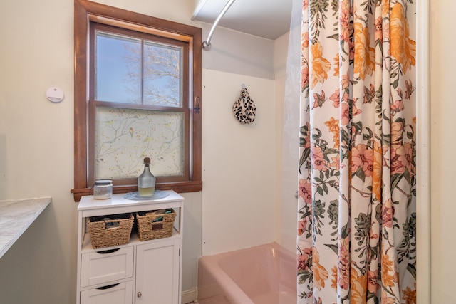 bathroom featuring shower / tub combo with curtain