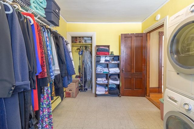 spacious closet featuring a baseboard radiator and stacked washer and dryer