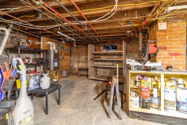 basement featuring radiator and brick wall