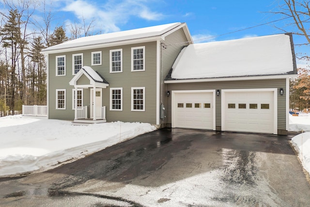 colonial house featuring driveway and an attached garage