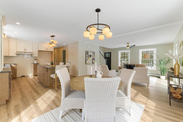 dining space with ceiling fan with notable chandelier, recessed lighting, a baseboard radiator, and light wood-style floors