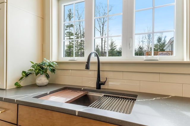 details featuring tasteful backsplash and a sink