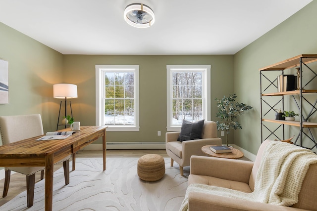 living area with baseboards, a baseboard heating unit, and wood finished floors