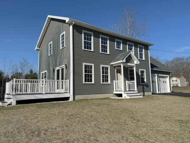 view of front facade with driveway, a deck, and a garage
