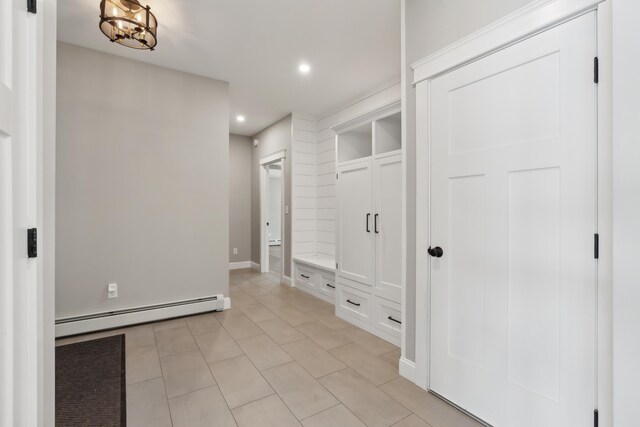 interior space with recessed lighting, baseboards, a notable chandelier, and baseboard heating