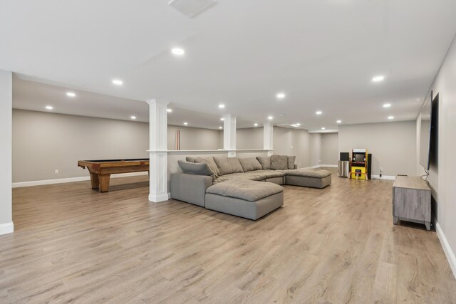 living area featuring light wood finished floors, baseboards, ornate columns, and recessed lighting