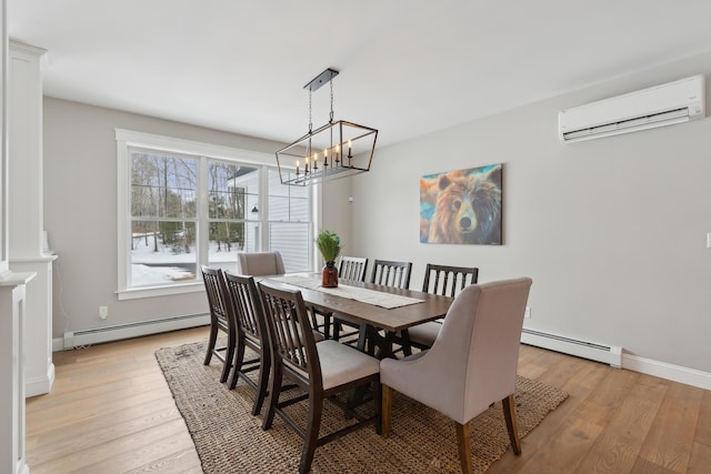 dining space featuring baseboards, light wood-style floors, a baseboard radiator, and a wall mounted air conditioner