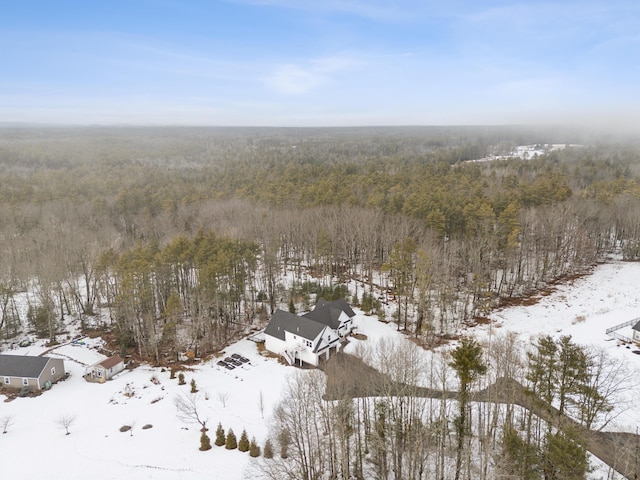 snowy aerial view featuring a view of trees