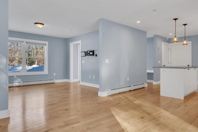 interior space with light hardwood / wood-style flooring and a baseboard radiator