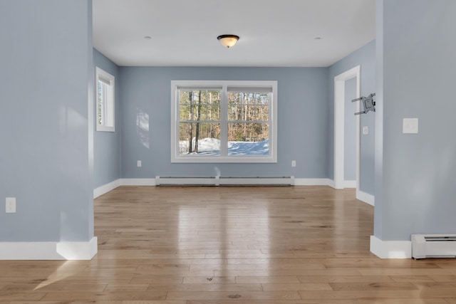 interior space featuring light wood-type flooring and a baseboard heating unit