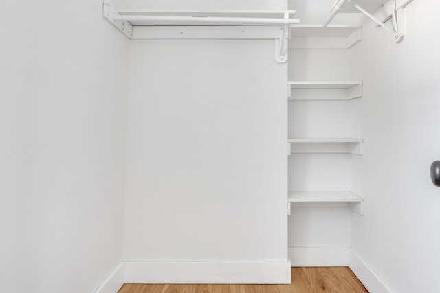 spacious closet featuring hardwood / wood-style floors