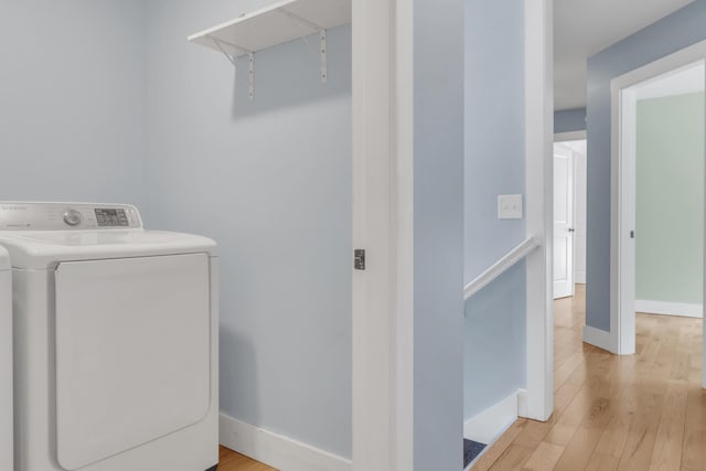 laundry room featuring washing machine and dryer and light wood-type flooring