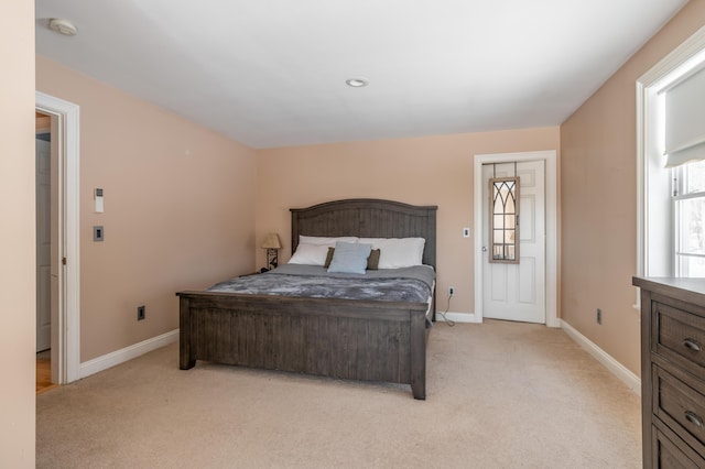 carpeted bedroom with multiple windows