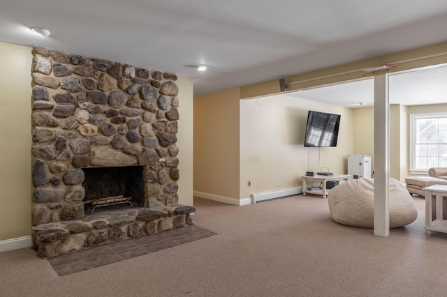 living room featuring a baseboard radiator, a fireplace, and carpet