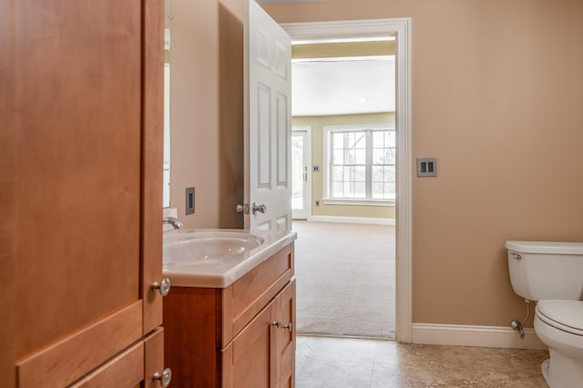 bathroom featuring vanity, tile patterned floors, and toilet