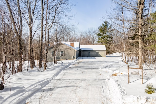 yard layered in snow with a garage