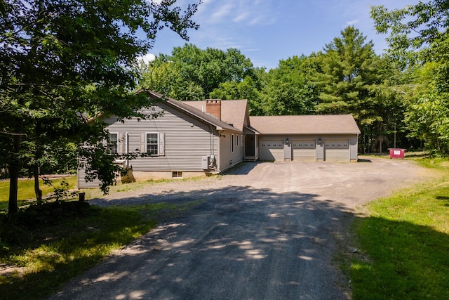 40 Penobscot Ridge Rd, Charleston, ME 04422 - view of front of home featuring asphalt driveway, a garage, and a chimney