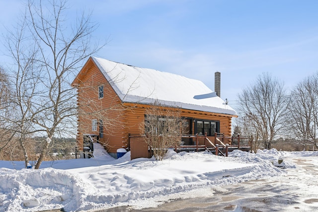 view of snow covered rear of property