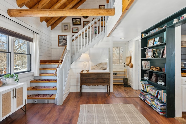 stairs featuring hardwood / wood-style flooring, wooden ceiling, lofted ceiling with beams, and wood walls