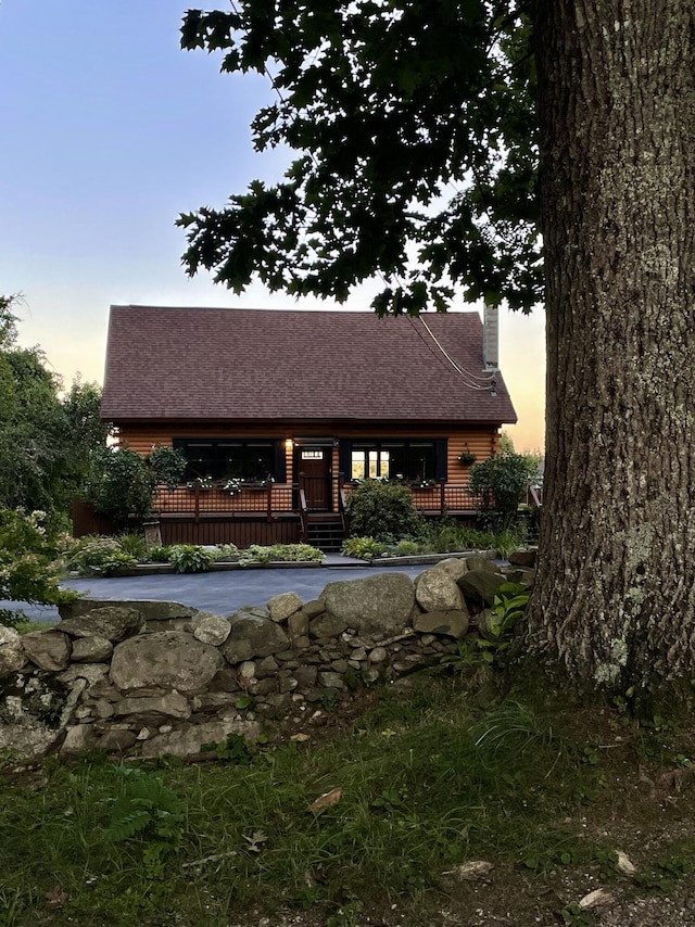 pool at dusk featuring a wooden deck