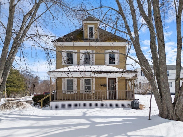 american foursquare style home with a porch