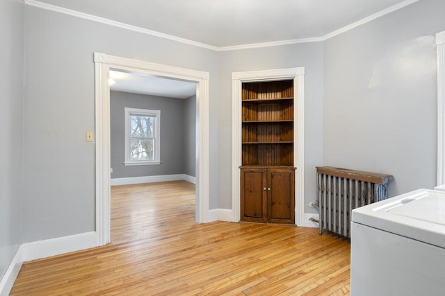 interior space with radiator, laundry area, washer / clothes dryer, light wood-style floors, and crown molding