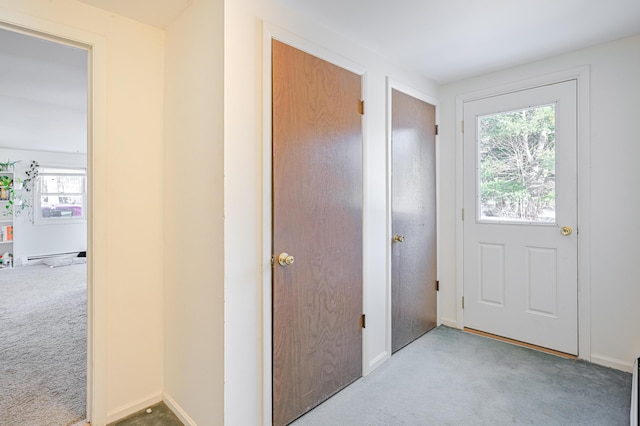 doorway to outside featuring light colored carpet