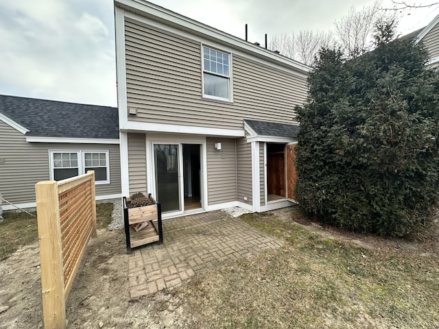 back of house featuring a lawn and a patio area