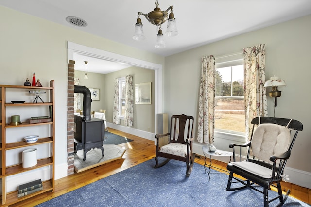 10 Leeman Hill Rd, Bristol, ME 04554 - sitting room with a wood stove, wood finished floors, and baseboards