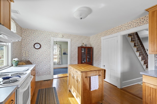 10 Leeman Hill Rd, Bristol, ME 04554 - kitchen with wooden counters, electric range, light wood finished floors, wallpapered walls, and baseboards